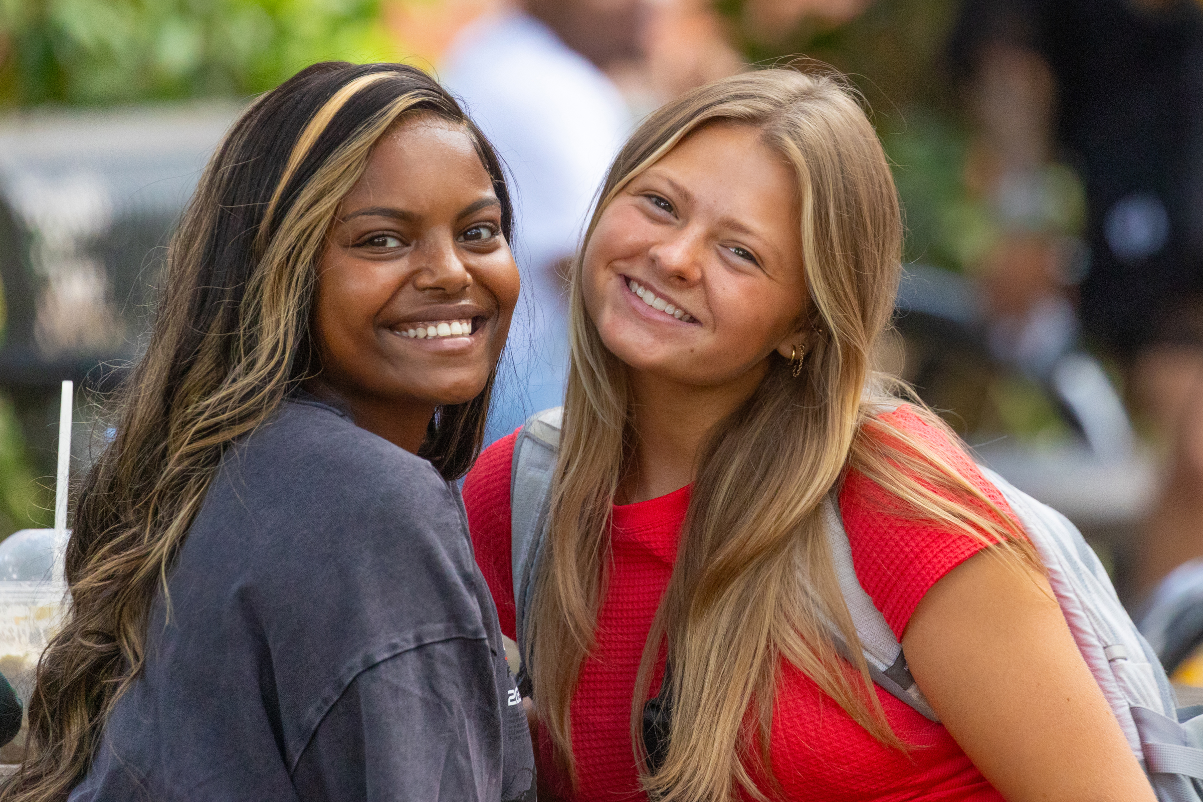 Two students smiling on campus